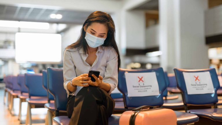 young-asian-tourist-woman-with-mask-using-phone-an-C43TS2R young-asian-tourist-woman-with-mask-using-phone-an-C43TS2R